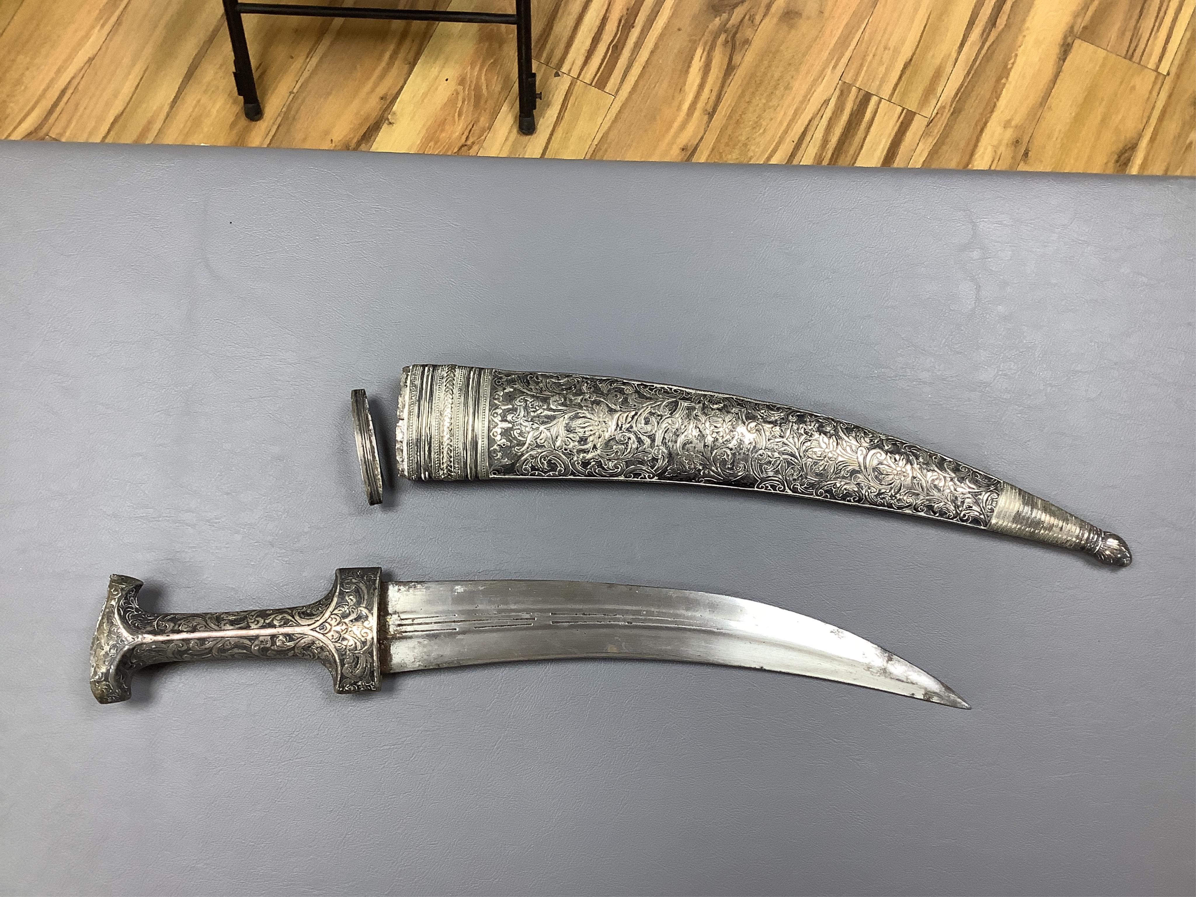 Eighteen assorted world weapons comprising a silver jambya (pommel missing), a knobkerry, a dha, two kris (one with handle missing), a lohar, three kukris, a djambok, a Chinese trousse, a chora, a flyssa, five others and